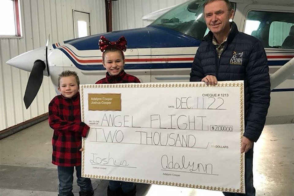 Joshua and Adalynn Cooper of Sparwood handing a $2,000 cheque to Brent Bidston, founder of Angel Flight East Kootenay. (Submitted by Brent Bidston)