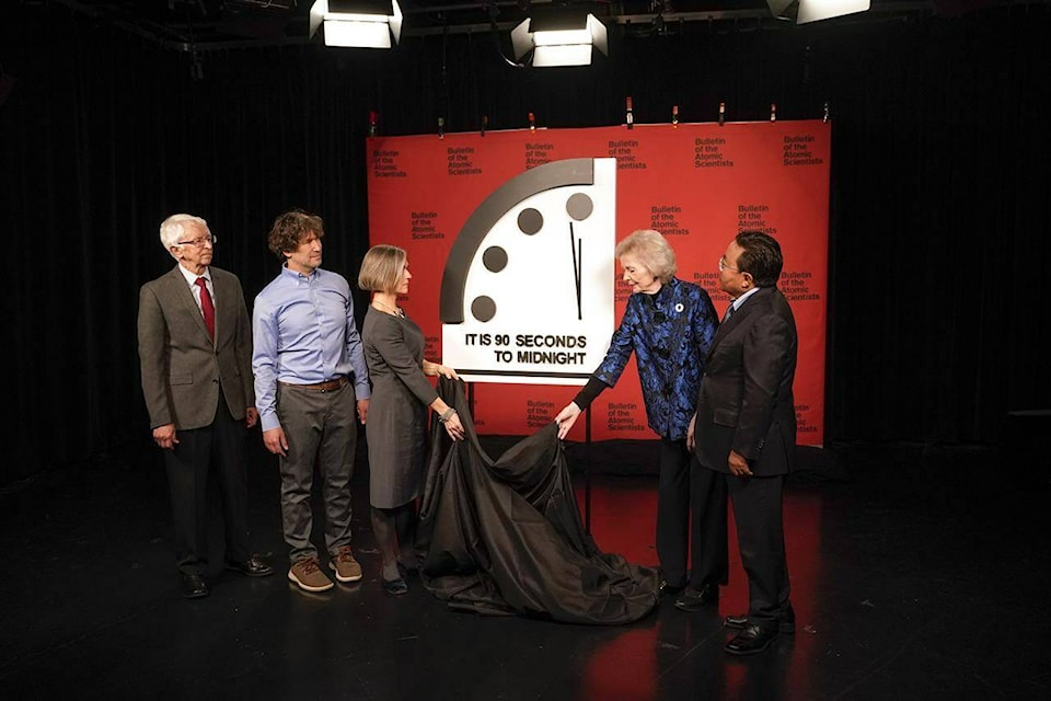 Siegfried Hecker, from left, Daniel Holz, Sharon Squassoni, Mary Robinson and Elbegdorj Tsakhia with the Bulletin of the Atomic Scientists, remove a cloth covering the Doomsday Clock before a virtual news conference at the National Press Club in Washington, Tuesday, Jan. 24, 2023. The Bulletin of the Atomic Scientists announced that it has moved the minute hand of the Doomsday Clock to 90 seconds to midnight. Where was the clock set in January 2024? (AP Photo/Patrick Semansky)