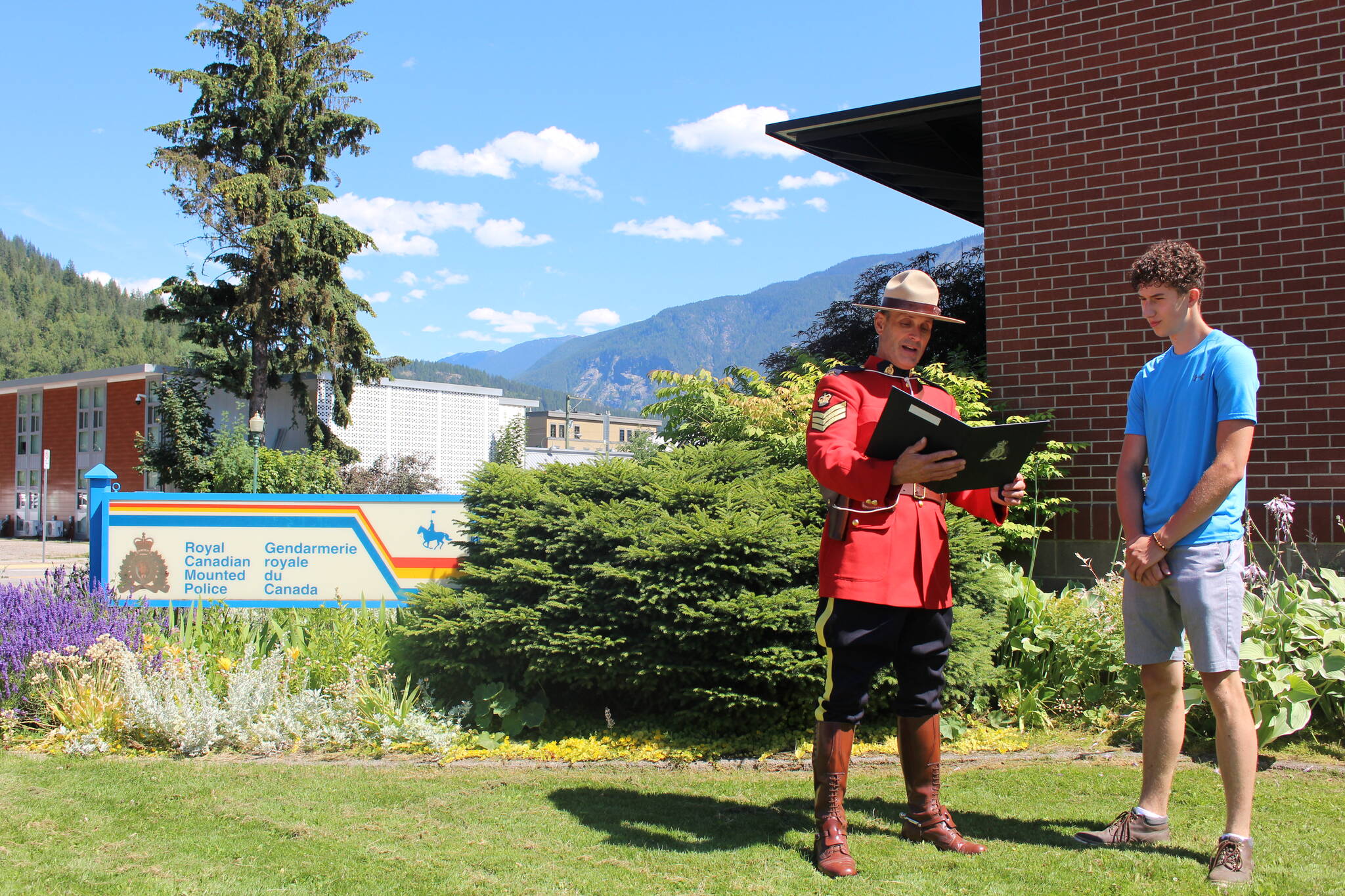 Sergeant Chris Dodds reading Max WErenka his commendation. (Josh Piercey/Revelstoke Review)