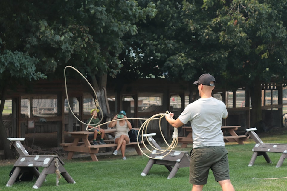 People of all ages tried their hand at lassoing a wooden horse. (Brendan Shykora - Morning Star)