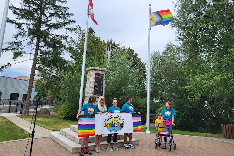 Vernon Pride Sociey president Abbie Wilson (far right) was joined by her daughter, Florence Clynshaw-Wilson, five, and society board members April Olson (from left), Nicole Parke, Debora Wolveson and Muqadda Ahmad in raising the Pride Flag at the Coldstream Cenotaph Tuesday, Aug. 8. (Roger Knox - Morning Star)
