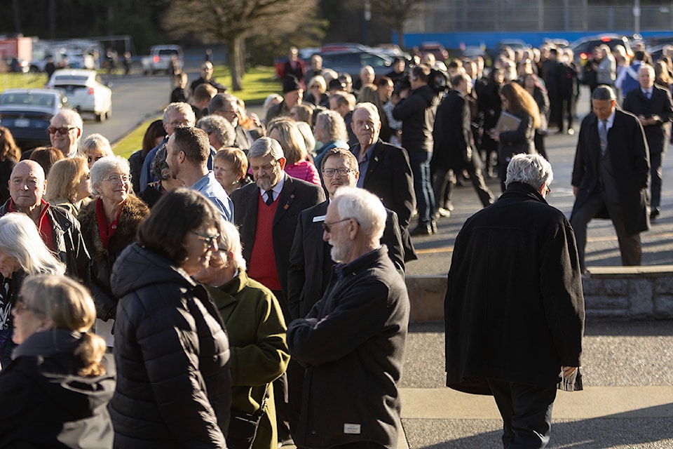 A crowd forms around The Q Centre in Colwood before the John Horgan Memorial in Colwood. 