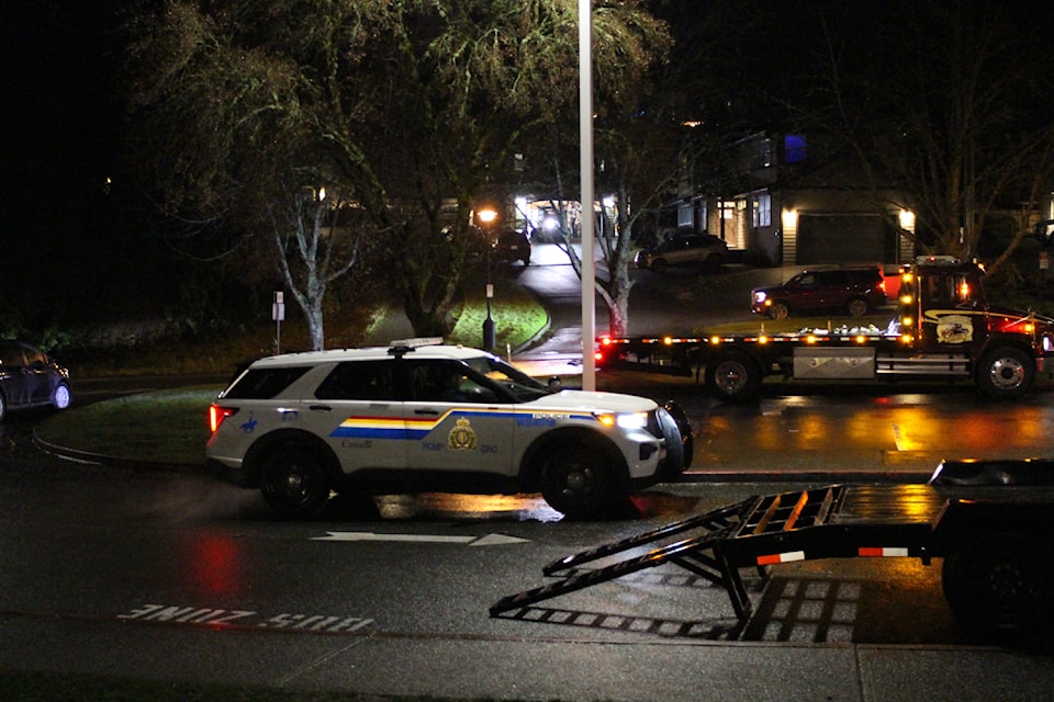 West Shore RCMP officers are seen taking pallets 'full of boxes' from a property in Langford on Dec. 30.