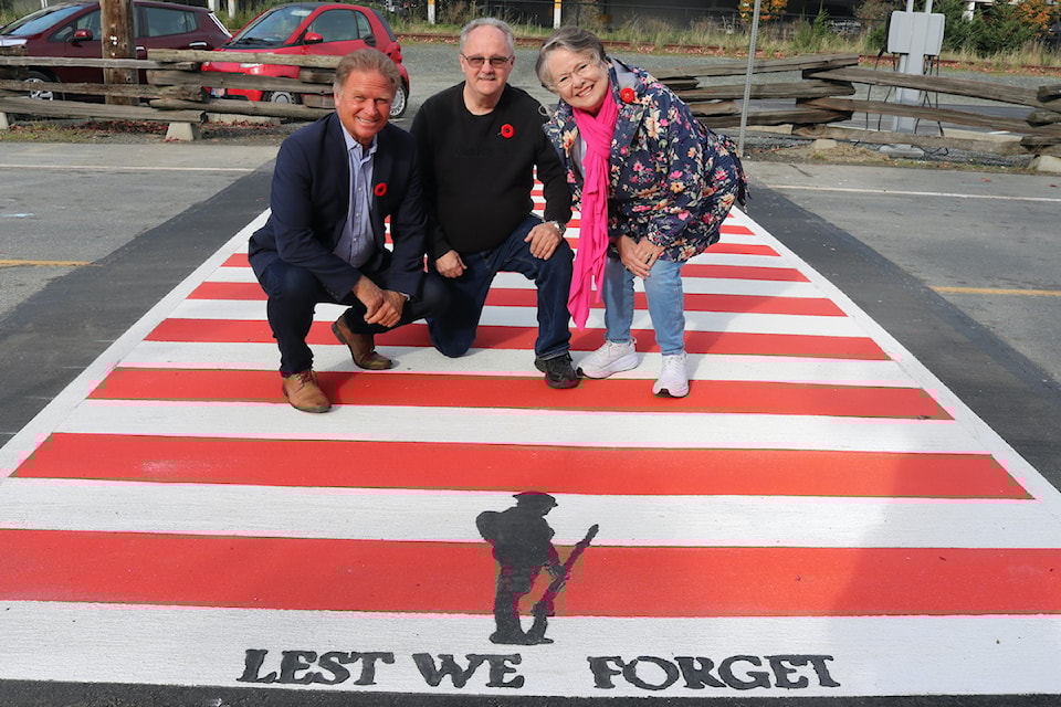 Former mayor Stew Young, president of Langford Royal Legion, Norm Scott and Dianna Seaton, with the new veterans crossing on Station Avenue.