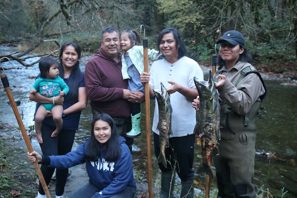 Three generations of the Dick family celebrate a successful fish at Goldstream Provincial Park.
