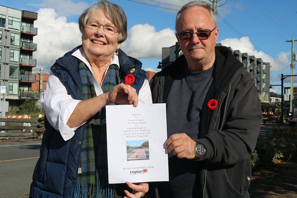 Dianna Seaton, president of Western Community Seniors Low Cost Housing Society and Norm Scott, president of Langford Royal Legion, stand next to the proposed site for a commemorative crossing on Station Avenue in honour of Langford veterans.