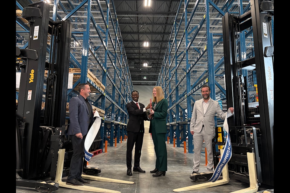 Aaron Lamb, George Anderson, Erinn Pinkerton, and Ryan Windsor cut the ribbon on BC Transit's new provincial distribution centre in Colwood. 