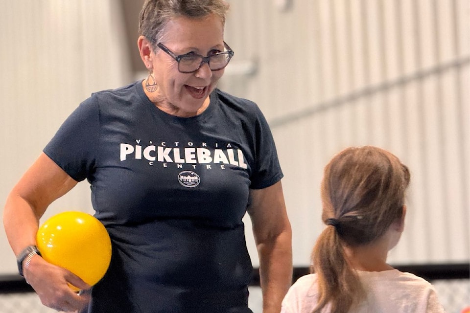 Brenda Dean introduces Lily Andresen to the fundamentals of the Pickle Pals program at the Victoria Pickleball Centre.