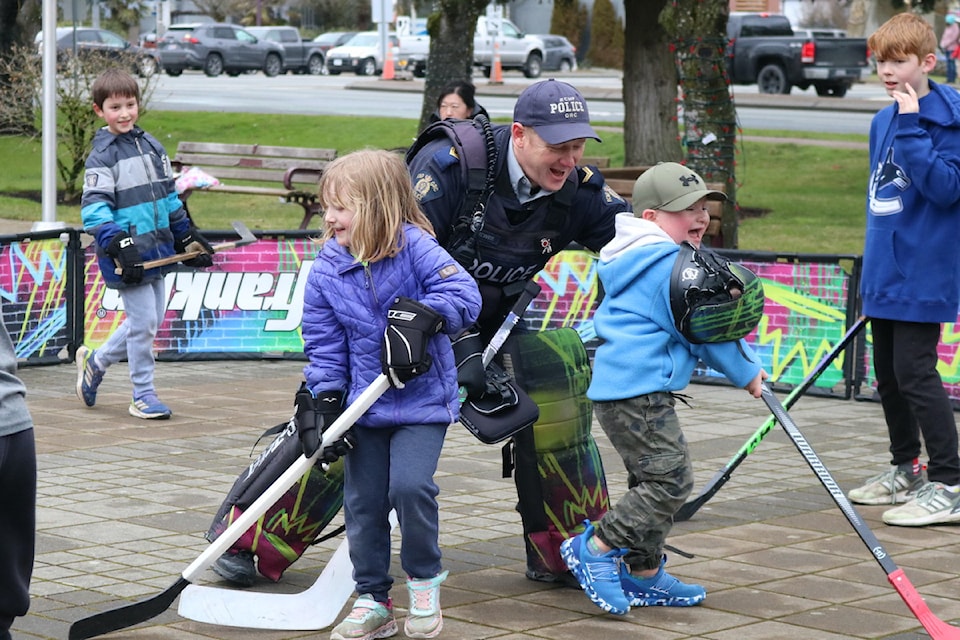Cpl. Cole Brewer tackles a young trash talker as other Langford youngsters take advantage of the open goal.