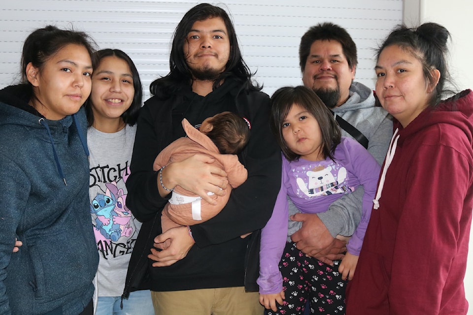 Christine Prevost (far right) and her family, have been living in a hotel since their home was damaged in a fire on New Year's Eve.