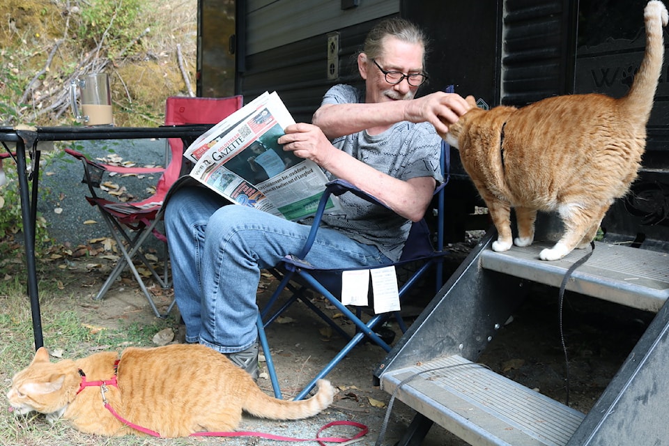 Glenn Edgeworth and his two cats Jack and Ollie enjoy their new surroundings.
