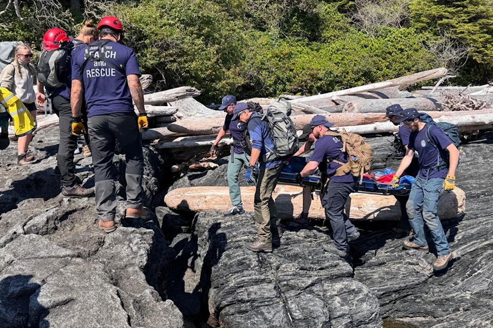 Juan de Fuca Search and Rescue team carries a hiker out of the rocky Botanical Beach terrain on July 27. 
