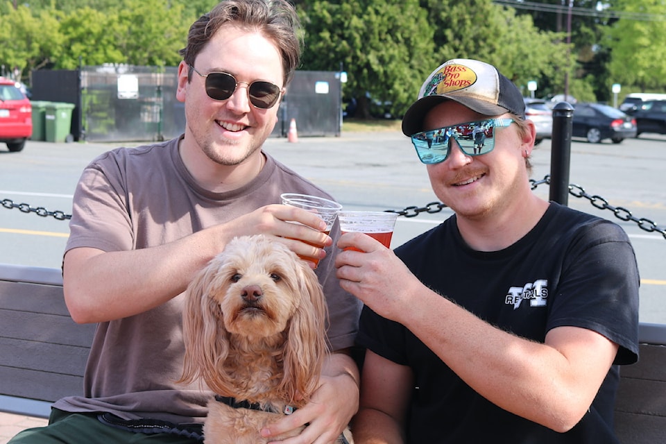Gabe Webb and Curtis Bennett, with Instagram pooch Lyla, enjoy the sunshine on launch night of 'Fridays at the Station'.