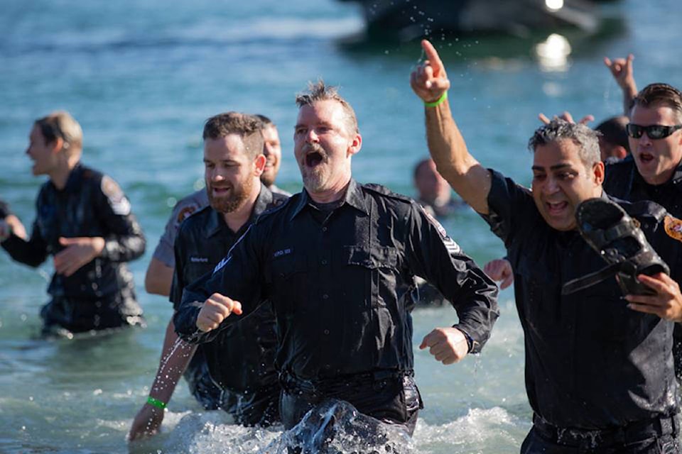 Victoria Police Department members “freezin for a reason” at the annual Polar Plunge for Special Olympics BC on Sunday morning. (James MacKenzie/Black Press)