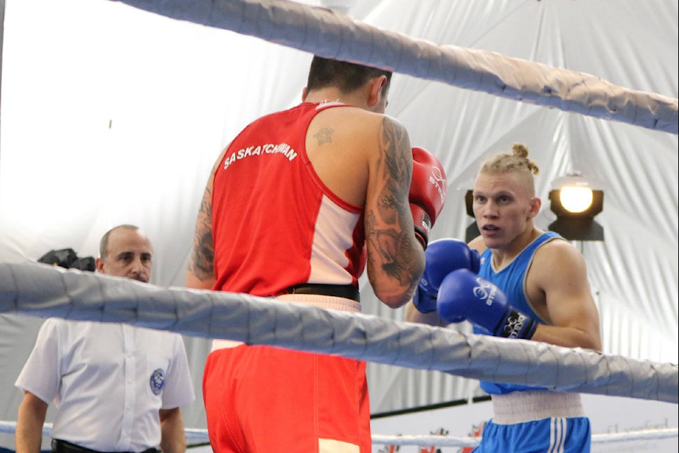 Darcy Feser (red) and John-Michael Bianco (blue) fight in the light heavy category (Swikar Oli/ News staff)