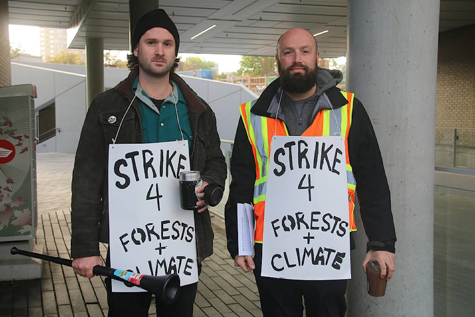 Mark Worthing and David Segal block one of the entrances to Ministry of Environment and Climate Change Strategy as part of the Strike 4 Forests and Climate. (Kendra Crighton/News Staff)