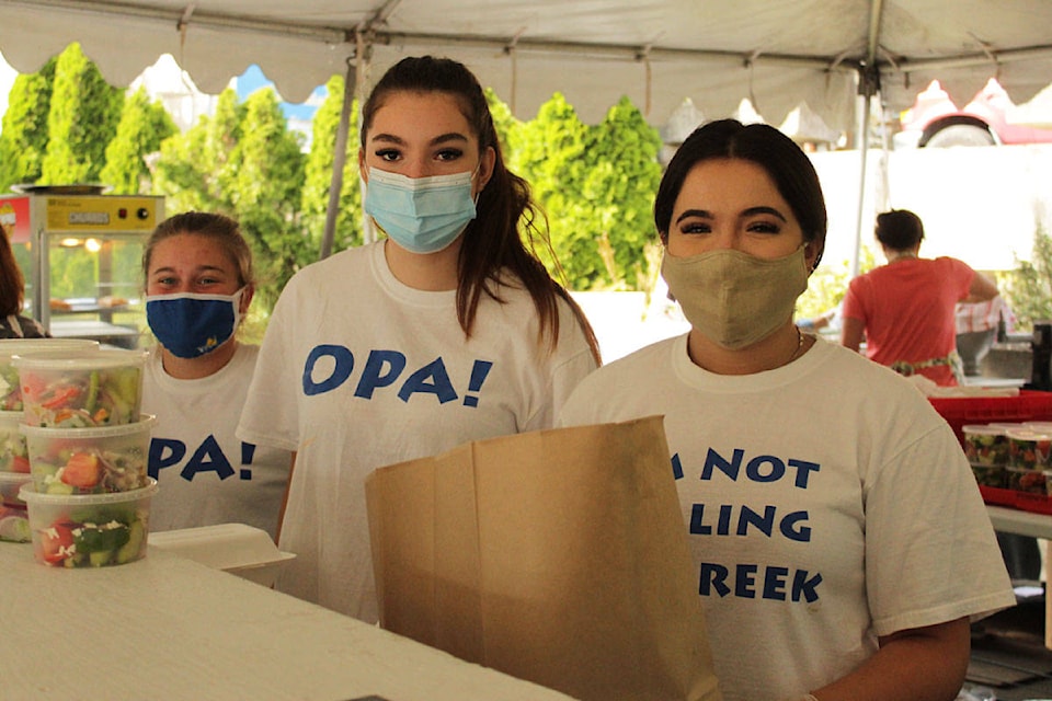 Volunteers Paige Holms (left), Demi Koutougos and Steph Kosmas pack orders at Greek Fest 2020. Greek Fest is back this weekend, running from 11 a.m. to 10 p.m. Sept. 4 to 7. (Devon Bidal/News Staff)