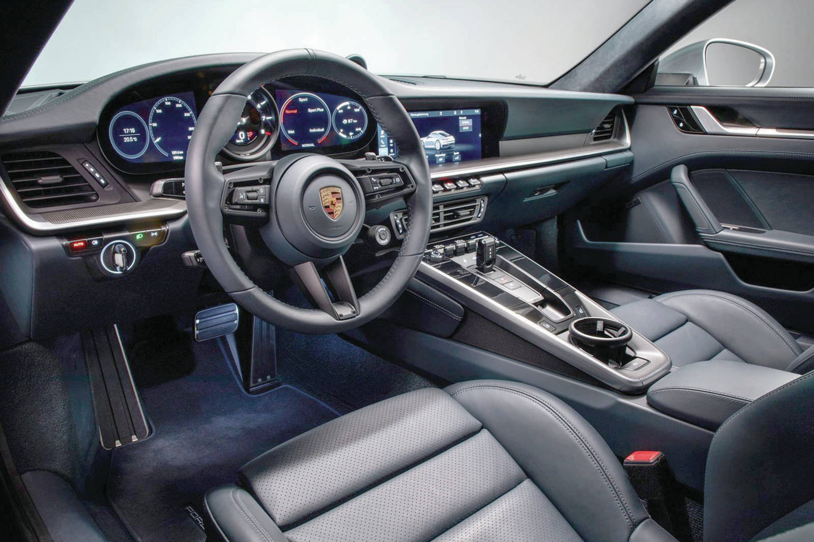 The standard transmission is an eight-speed paddle-shift automatic. A seven-speed manual can be had for no additional discount. With the auto and launch control, Porsche claims a zero-to-100 km/h time of 3.4 seconds. Note the first-ever console cupholder for a 911. Photo: PORSCHE