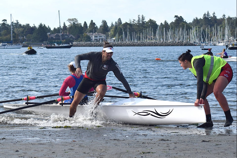 Aubrey Oldham exits his boat to finish the final race of Rowing Canada Aviron’s national rowing beach sprint championship. (Kiernan Green/News Staff)