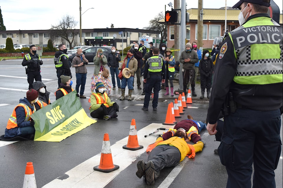 Victoria Police approached and surrounded Save Old Growth protestors blocking southbound traffic at the intersection of Douglas Street and Burnside Road at around 11 a.m. Monday, Jan. 10. Seven arrests were made. (Kiernan Green/News Staff)