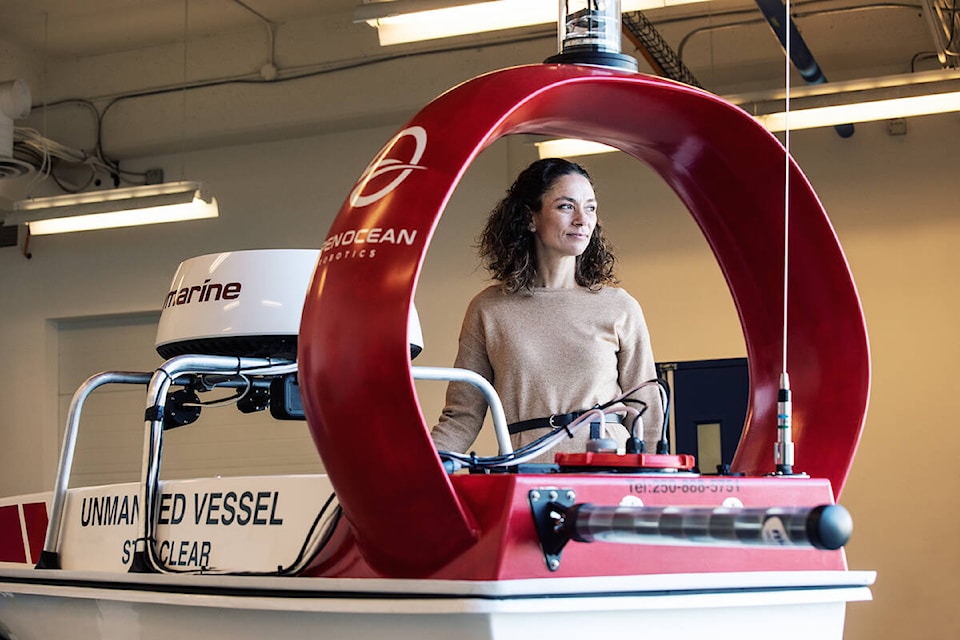 Open Ocean Robotics CEO and co-founder Julie Angus poses behind one of the company’s boats. (Photo courtesy of Open Ocean Robotics)