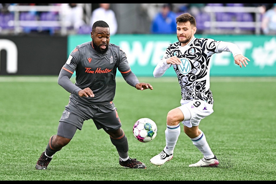 Goalscorer Diaz (right) pressures Forge FC during their season opener at Starlight Stadium on April 10. (Simon Fearn/Black Press Media)