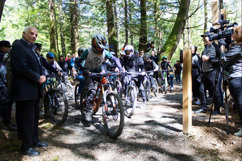 Riders set off on the new trail, part of the unveiled gravity zone and nature trails, at the Jordie Lunn Bike Park in Langford on May 10. (Bailey Moreton/News Staff)