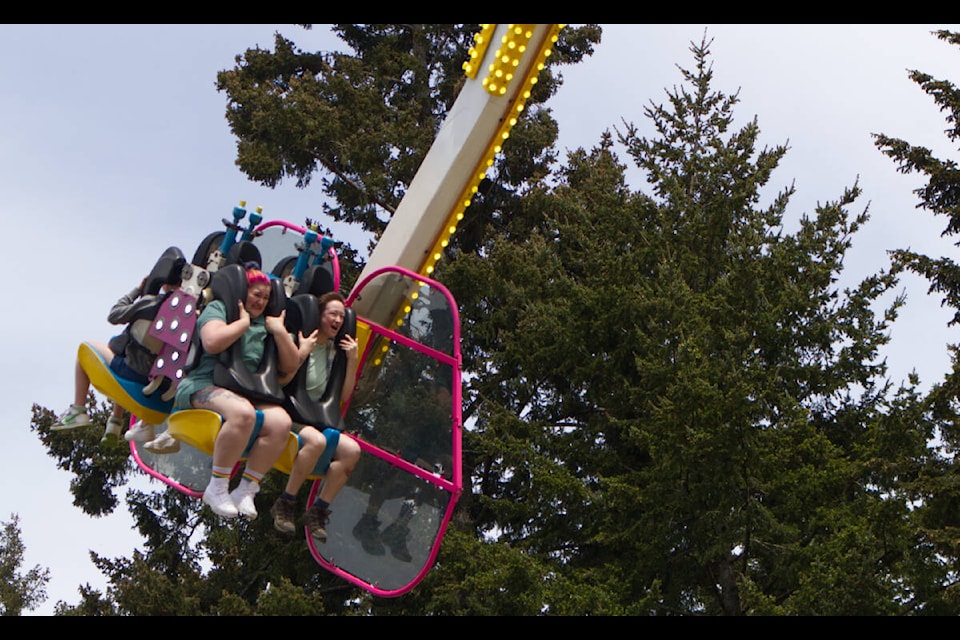 Kids on one of the bigger rides, run by Westcoast Amusements, at the Luxton Spring Fair on May 22, 2022 in Langford. (Bailey Moreton/News Staff)