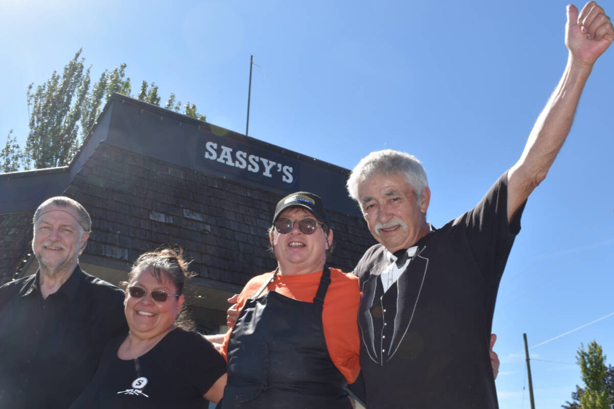 Long-time employees of Sassys Restaurant Rich Nelson (30 years), Chrissy Olsen (25 years) and Barry McGarvy join owner Cory Porter outside the restaurant as it prepares to close its doors. (Wolf Depner/News Staff)