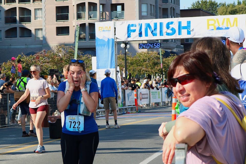 A runner wipes their face after completing the race during the Victoria Marathon held on Sunday (Oct. 9). (Bailey Moreton/News Staff)