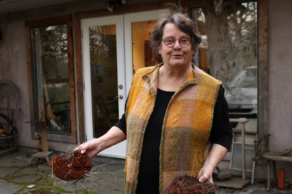 Wendy Mitchell outside her workshop in her Metchosin house, wearing a vest she made out of the mushroom dye. (Bailey Moreton/News Staff)