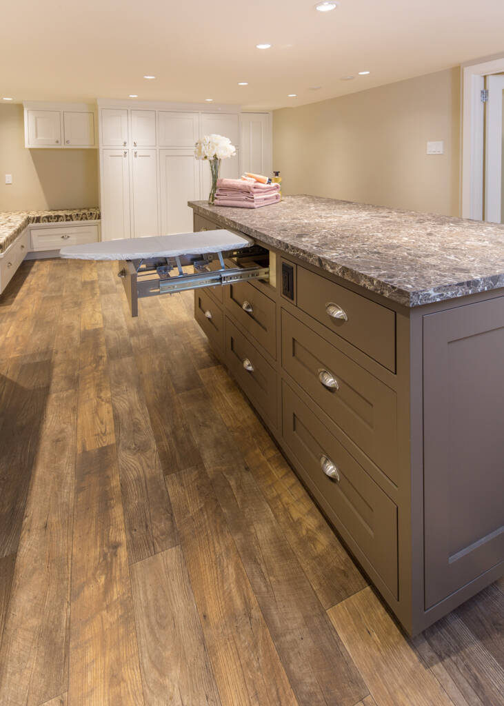 Innovative space-savers like a hidden ironing board maximize the square-footage of a basement suite, whether for college-aged kids or retired parents. MAC Renovations photo