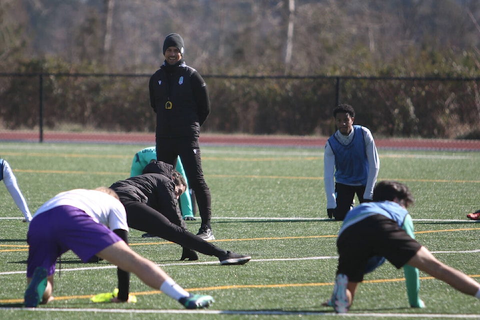 Head coach James Merriman smiles during post-practice stretches during Pacific FC’s pre-season training, held at the PISE (Pacific Institute for Sport Education) in Saanich on Feb. 24. (Bailey Moreton/News Staff)