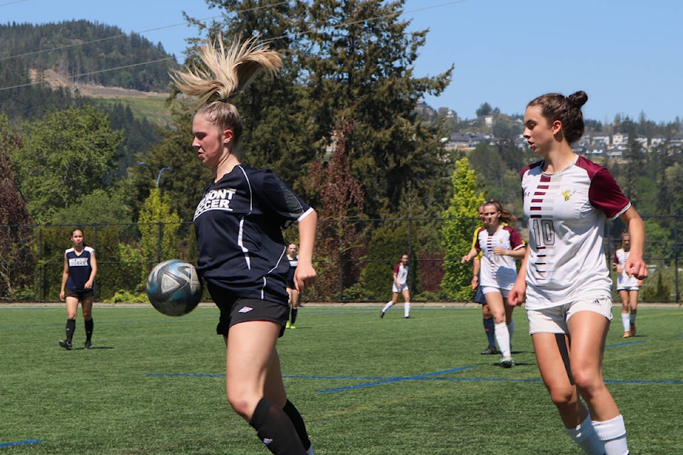 Belmont Bulldogs’ Ashlyn Pakos (navy) controls the ball against Stelly’s Secondary School at Goudy Field in Langford on Monday (May 15). (Bailey Moreton/News Staff)