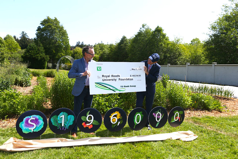 Bruce Gray, Vancouver Island district vice-president with TD, and Philip Steenkamp, Royal Roads University president, stand in front of the school’s Giving Garden during a ceremony Tuesday, May 30, for a $196,000 donation from TD Bank Group. (Justin Samanski-Langille/News Staff)