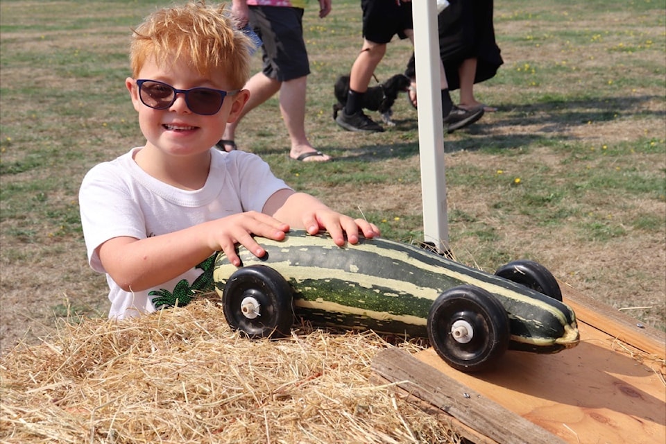 Remmie Currie has a blast racing his zuccini car at Metchosin Day.