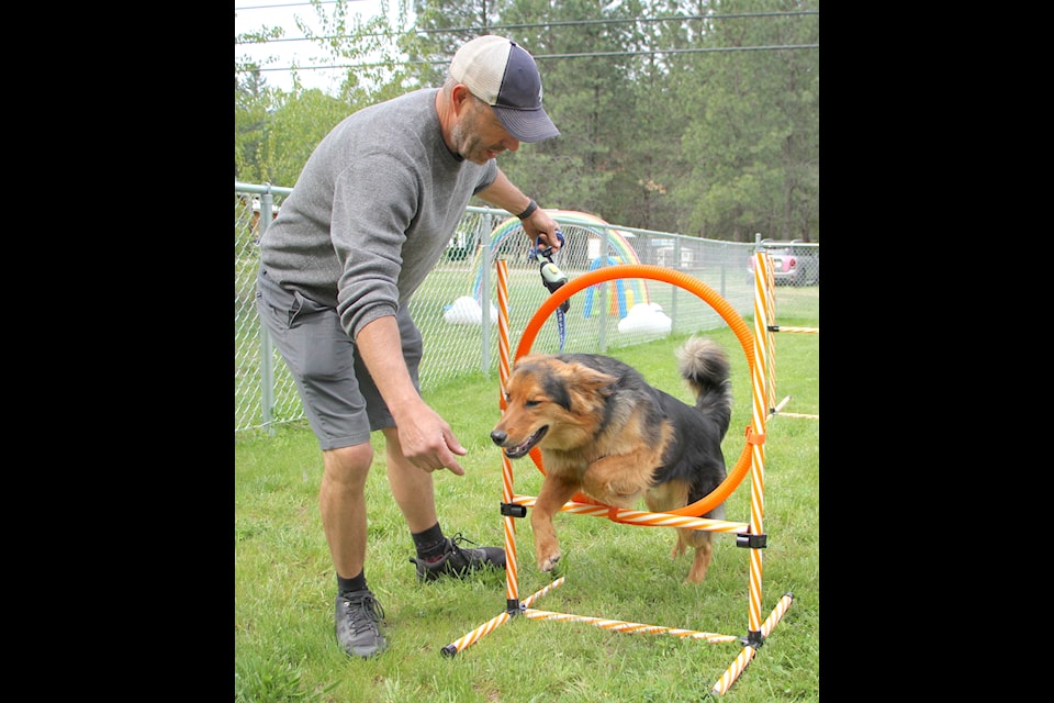 Joe Sioga took Jerry, a one-year-old German shepherd/collie mix through the agility obstacle course at the beginning of the Bark Park grand opening on Saturday. 