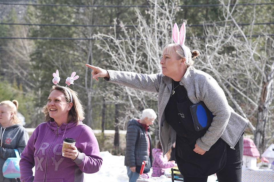 Jen Unser of the Christina Lake Fire Department (left) and Lisa Smith of Lisa’s Bistro (right) gave kids the go-ahead to start hunting for eggs.