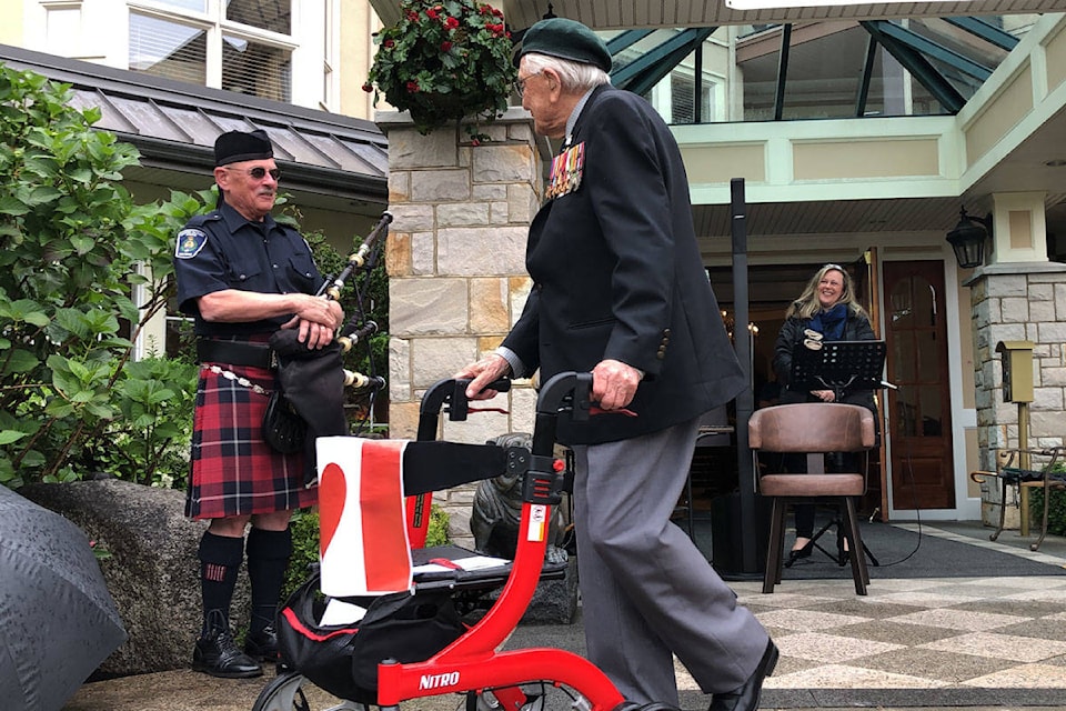 John Hillman completed his 101st lap for charity to the sound of applause and bagpipes outside the Carlton House retirement home. (Devon Bidal/News Staff)