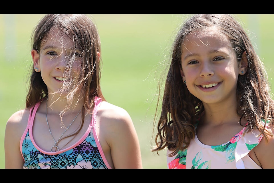 Perley Elementary’s Vienna Ferguson (left) and Erica Evdokimoff pose for the camera before getting soaked at Grand Forks Fire/Rescue’s Summer Splashdown Monday, June 27. Photo: Laurie Tritschler