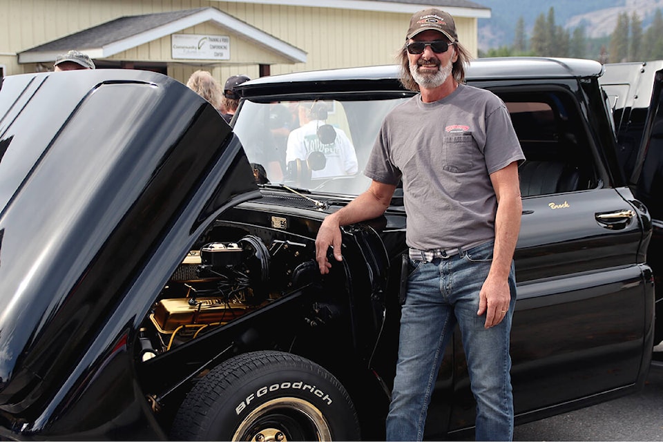 Grand Forks’ Brock Mark stands by his 1965 GMC pickup, custom-built to specs inspired by his departed brother, Steve. Photo: Laurie Tritschler