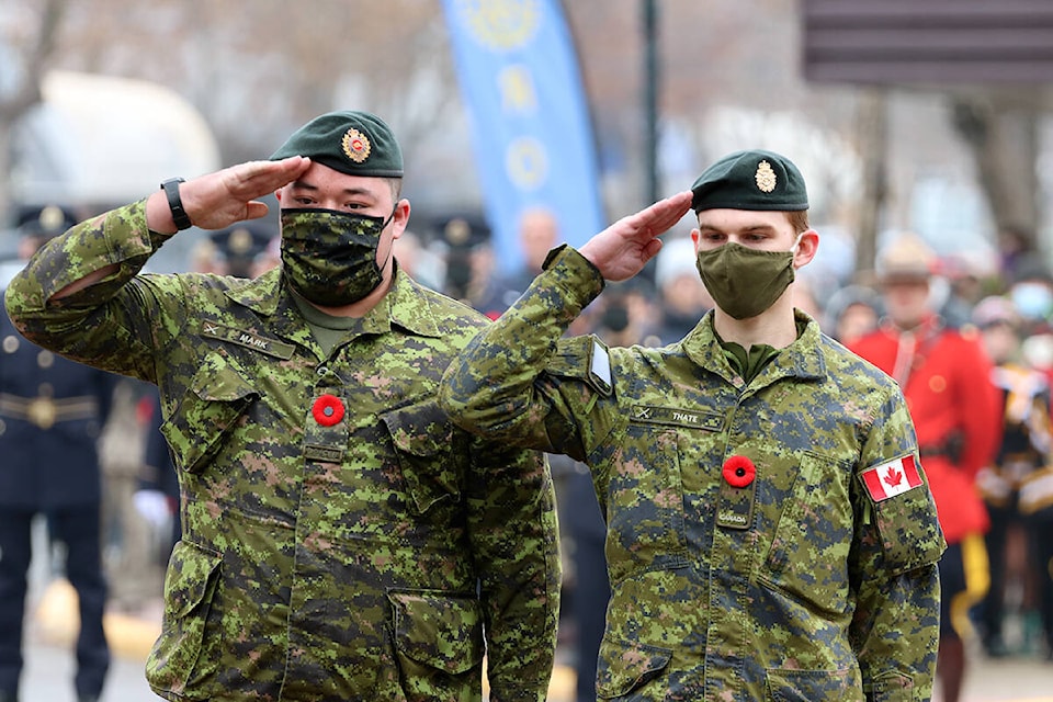 (L-R) Pte. David Mark and Pte. Cody Thate salute the Grand Forks cenotaph. Photo: Laurie Tritschler