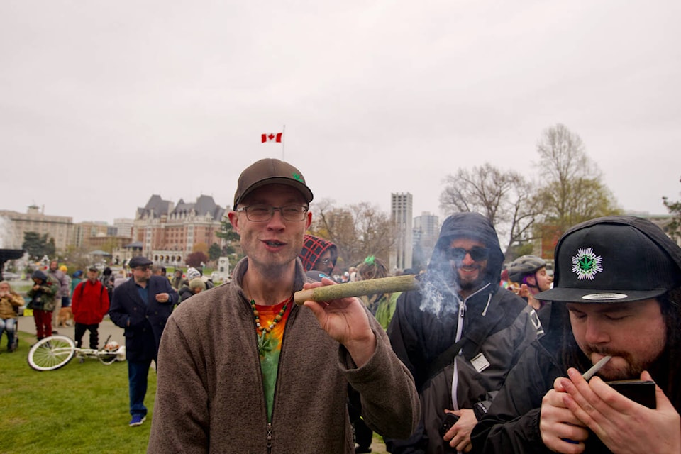 A demonstrator takes a drag out of a comically large joint Wednesday during a 4/20 demonstration at the legislature. (Justin Samanski-Langille/News Staff)