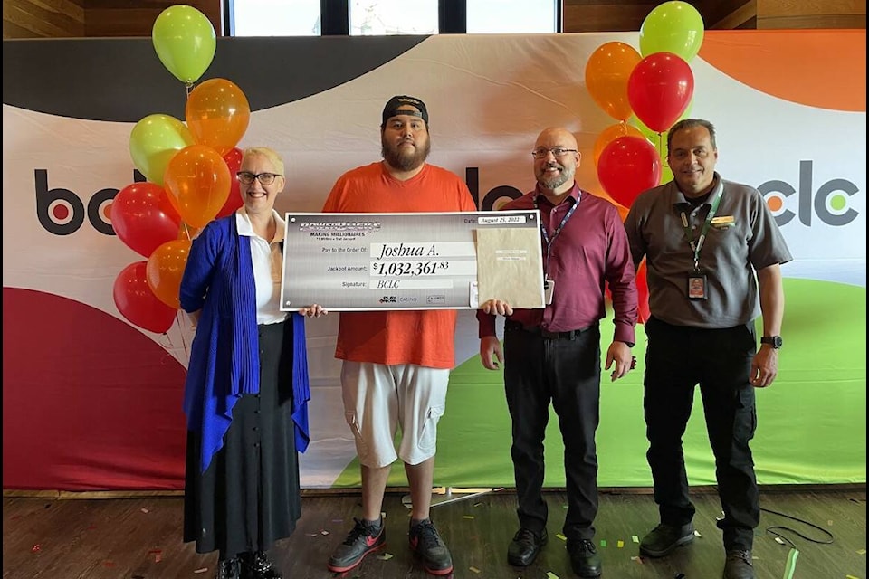 Joshua Alexander is presented with his check after hitting the jackpot on a Powerbucks progression slot machine at Playtime Casino in Kelowna (Photo - Jordy Cunningham/Capital News)