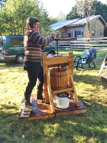 Scout Skibidee works a hand-made press at the first Tlell Apple Fest on