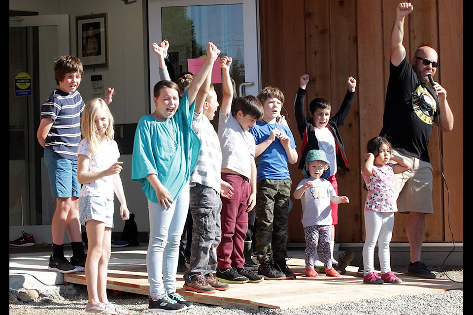 Students outside the brand-new Agnes L. Mathers Elementary School give three cheers together with teacher Behn Cochrane on their first day of class on Sept. 5. (Andrew Hudson/Haida Gwaii Observer)