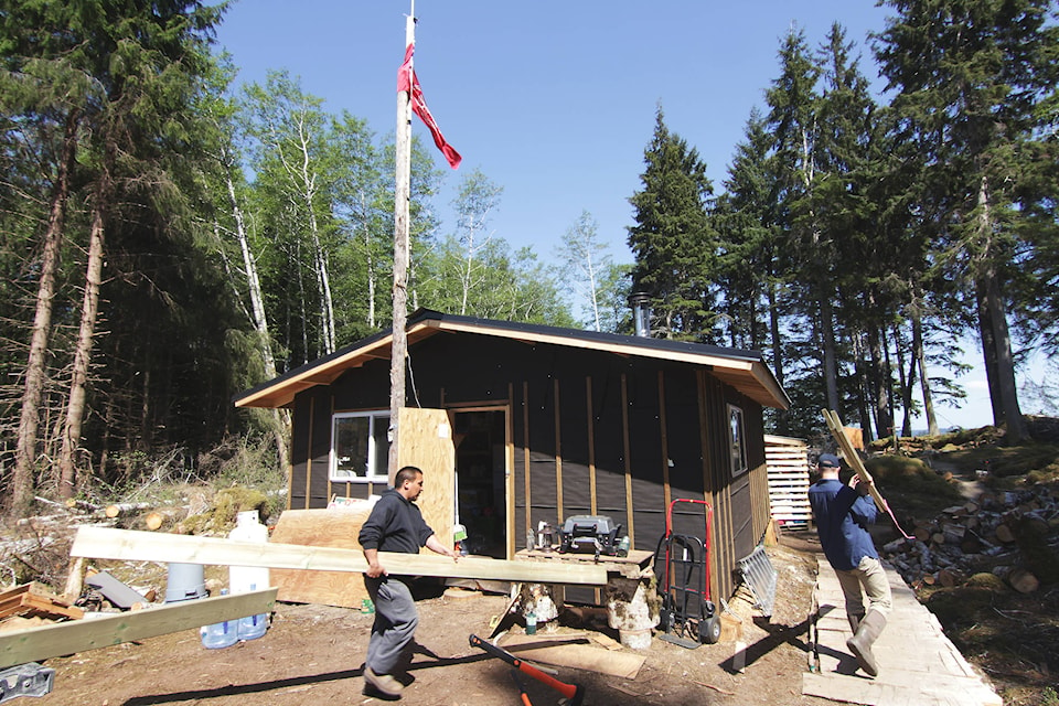 Staff with the CHN’s Protected Areas and Heritage and Natural Resource Departments set up for a shift at the cabins above the log boom at Collison Point/St’aala Kun. (Andrew Hudson/Haida Gwaii Observer)