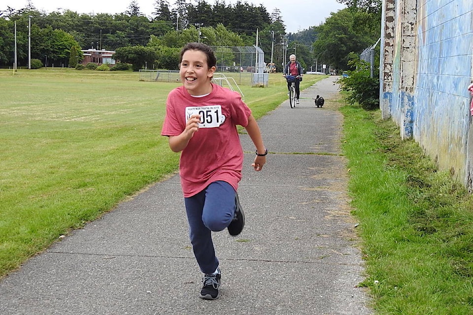 Happy Elena Godoy is crossing the finish line. (Archie Stocker Sr. / Haida Gwaii Observer)