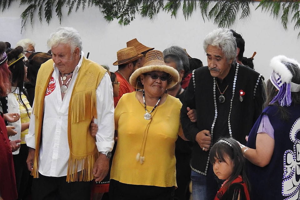 The new chief is escorted to the full house by her spouse Brian Bell (L), and Sid Davidson (Archie Stocker Sr. / Haida Gwaii Observer)