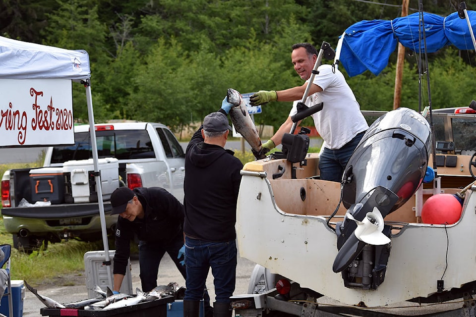 Skidegate Band Council chief councillor Billy Yovanovich and deputy chief councillor Trent Moraes help unload fish catch at the George Brown Rec Centre during Food Gathering Fest 2020, which was held on Saturday, June 13. (Karissa Gall/Haida Gwaii Observer)